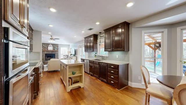 a living room with stainless steel appliances granite countertop furniture a kitchen view living room and windows