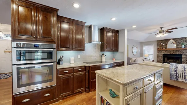 a kitchen with stainless steel appliances granite countertop a stove a sink and a microwave