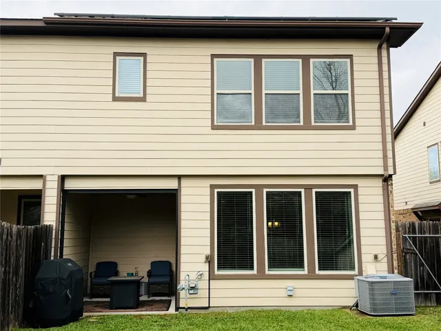 a view of a house with more windows and a yard