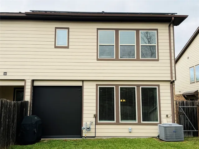 a view of a house with a yard and a large window