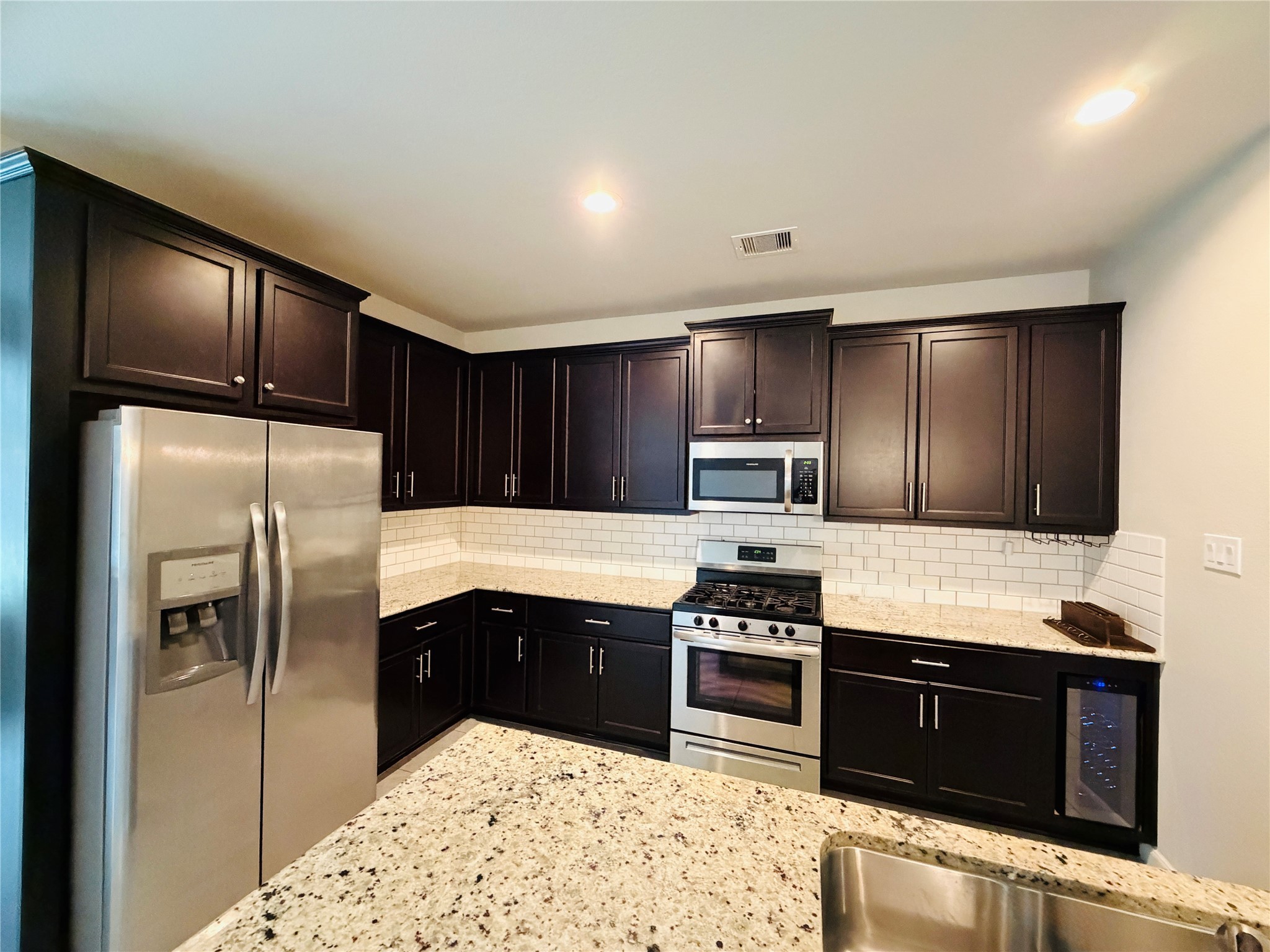 3318 Rainflower Springs Lane Rosenberg, TX 77471 - Photo 3 of 19 a kitchen with stainless steel appliances granite countertop a refrigerator stove and oven