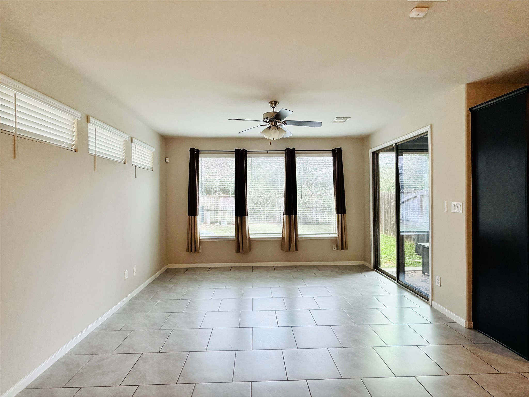 3318 Rainflower Springs Lane Rosenberg, TX 77471 - Photo 4 of 19 a view of an empty room with a window