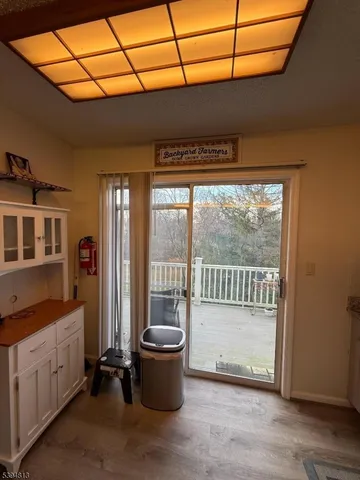 a view of balcony with wooden floor and fence