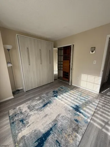 a room with gym equipment and wooden floor