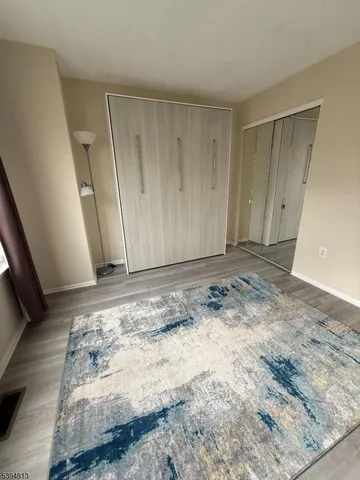 a bedroom with furniture and a flat screen tv