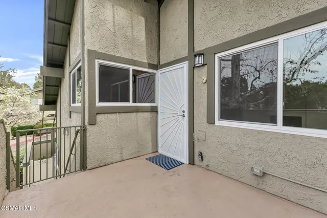 a view of a room with wooden floor and entryway