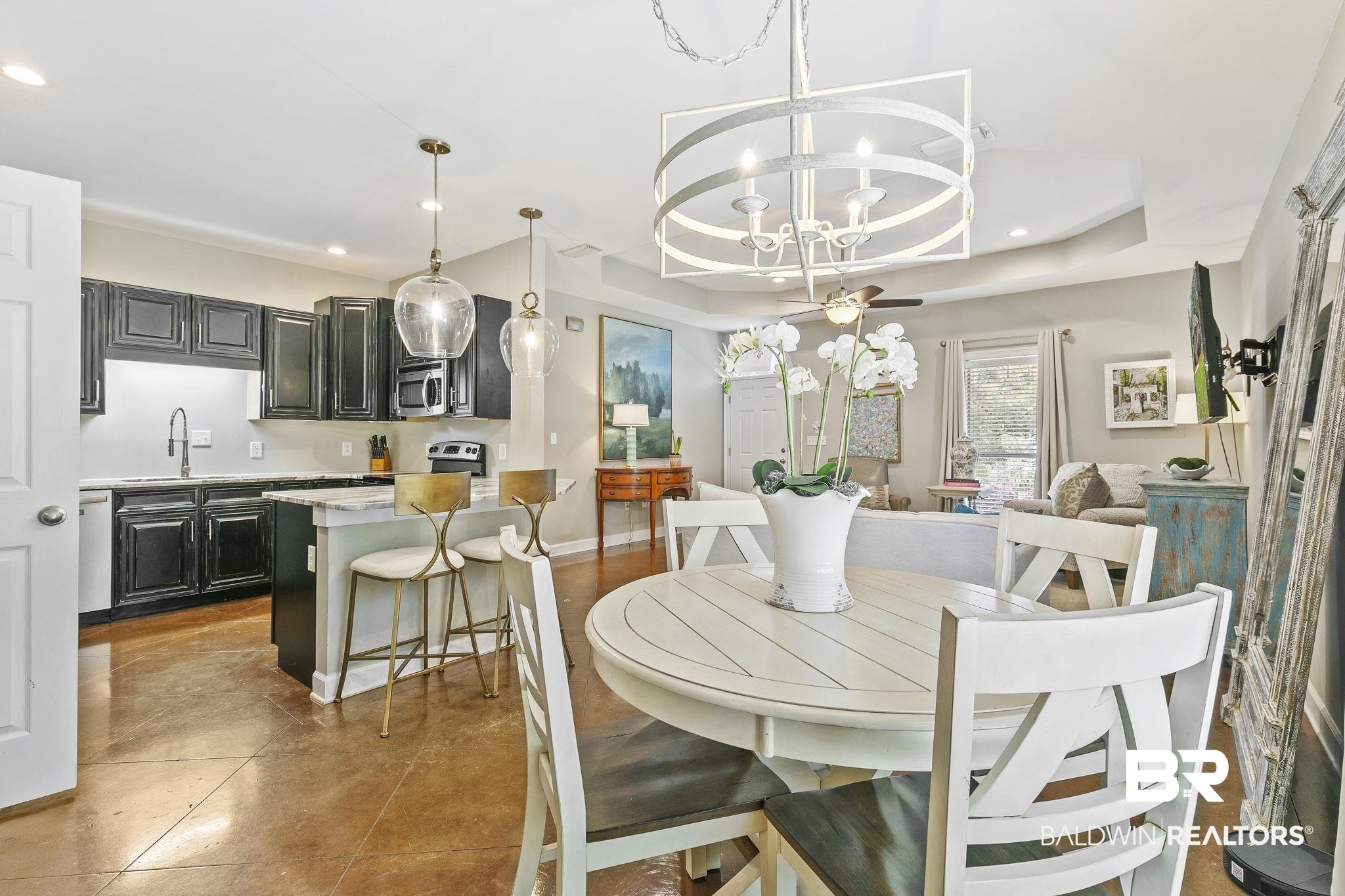 32072 Buzbee Road Daphne, AL 36527 - Photo 12 of 41 Dining area featuring an inviting chandelier, sink, and a tray ceiling
