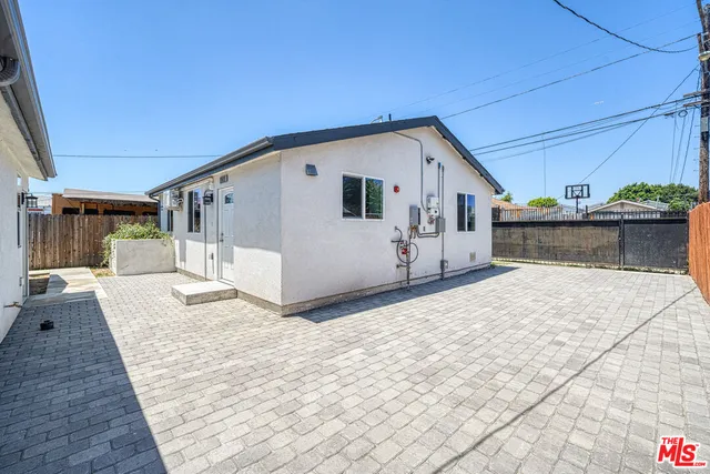 a view of house with backyard and sitting area