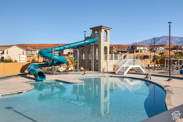 1329 Paseos Street Washington, UT 84780 - Photo 30 of 35 Community pool with a water slide, a residential view, a mountain view, and a patio area