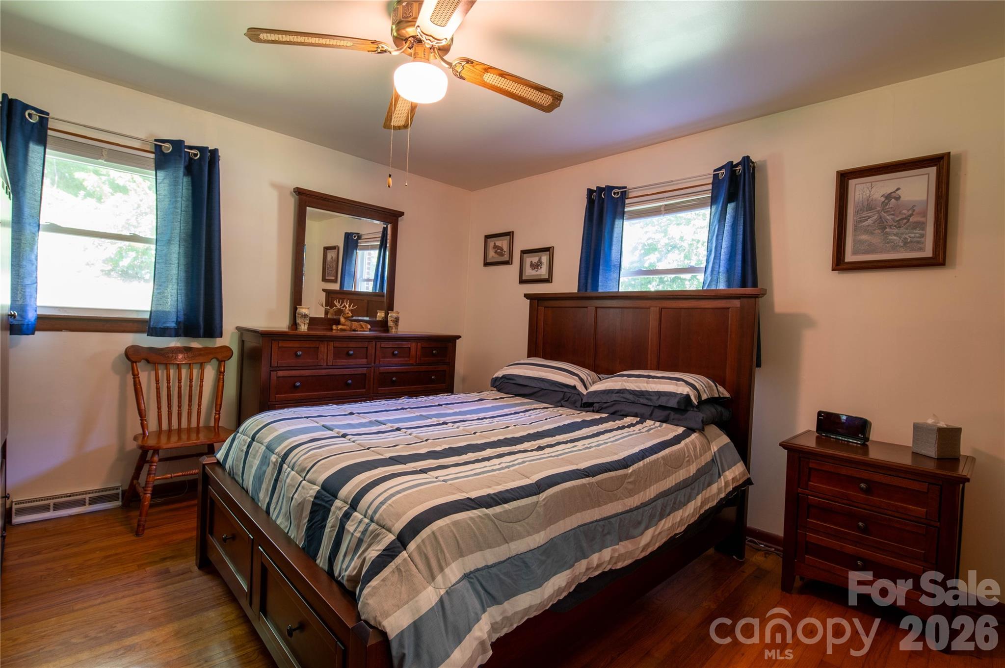 40 Double Island Road Burnsville, NC 28714 - Photo 22 of 38 a bedroom with a bed and wooden floor