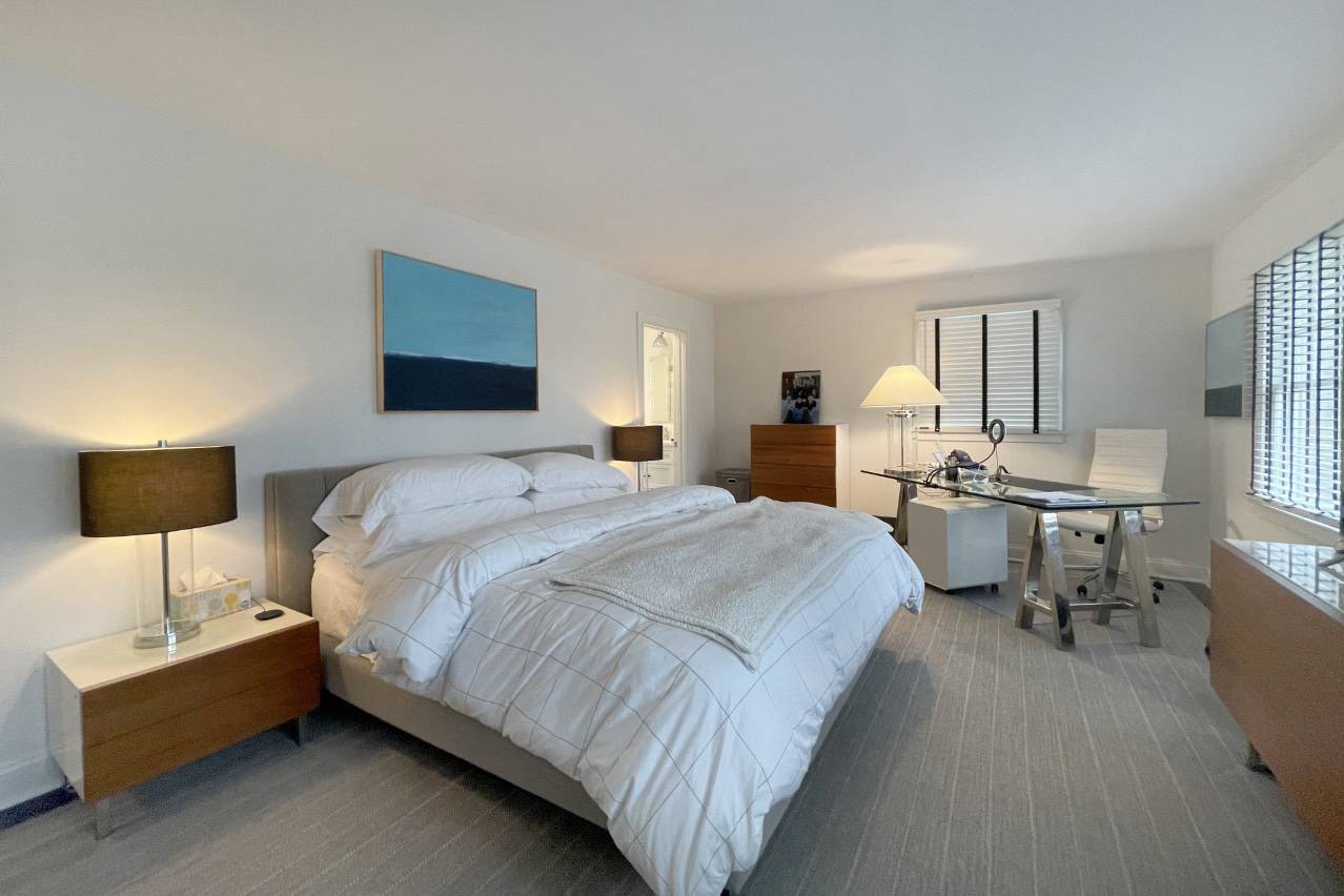 475 7 Ponds Towd Road Water Mill, NY 11976 - Photo 11 of 18 a bedroom with a bed and a table in it