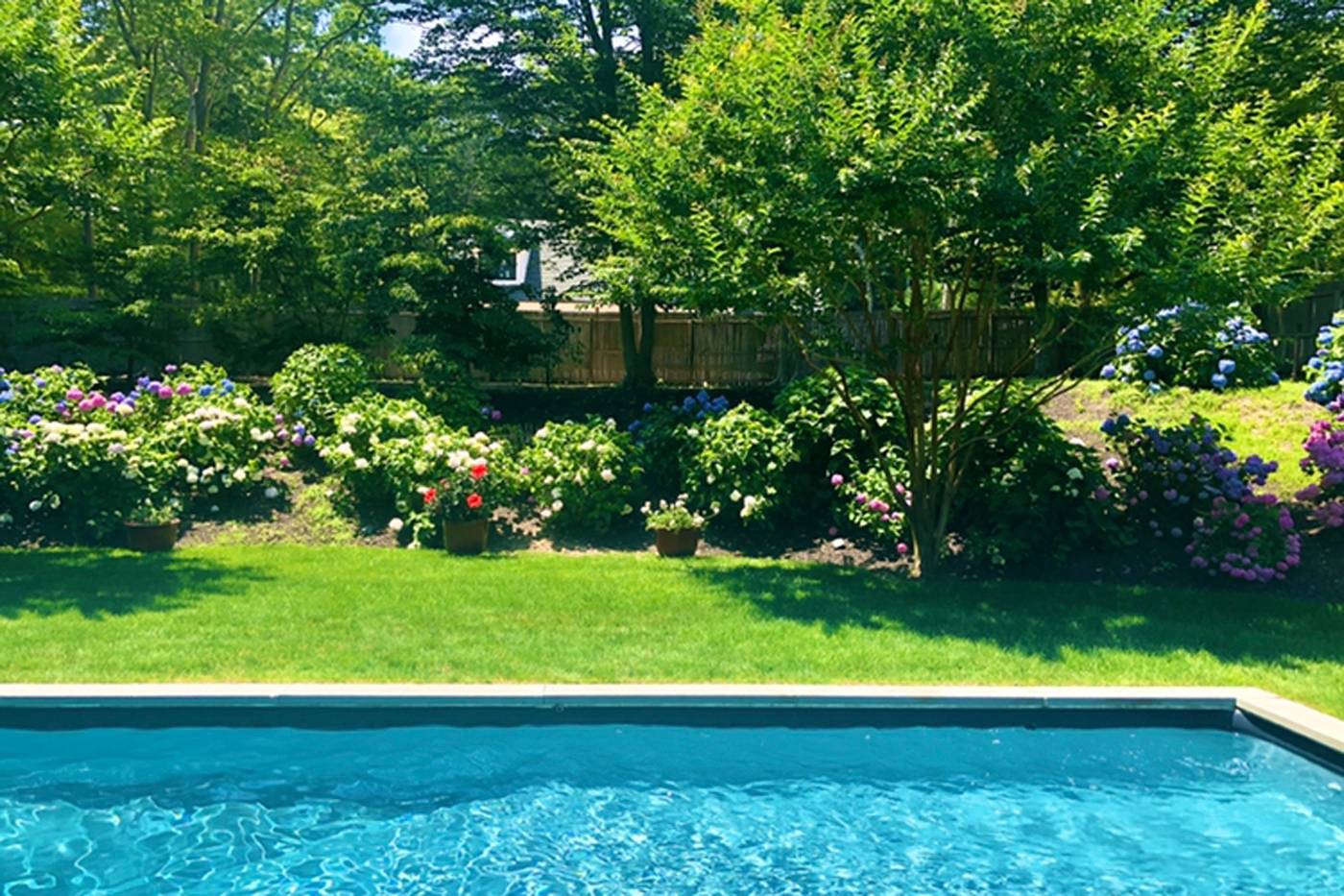 475 7 Ponds Towd Road Water Mill, NY 11976 - Photo 18 of 18 a view of pool with a garden and trees