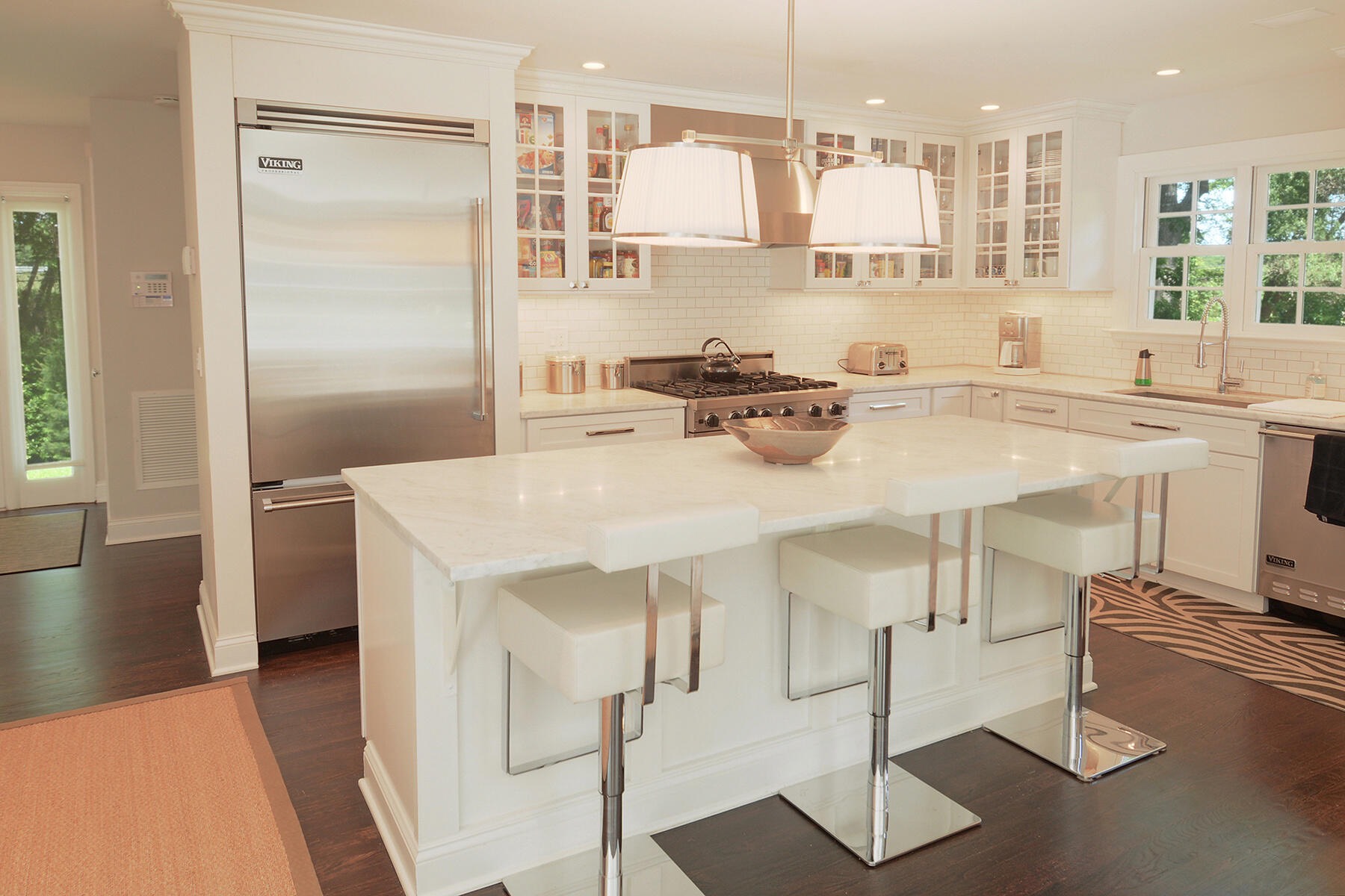475 7 Ponds Towd Road Water Mill, NY 11976 - Photo 6 of 18 a kitchen with stainless steel appliances kitchen island granite countertop a refrigerator a stove and white cabinets with wooden floor