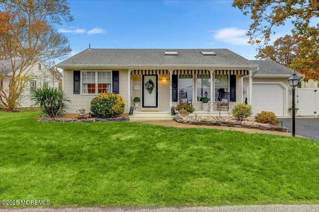 a front view of a house with a yard table and chairs