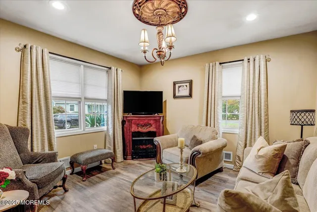 a living room with furniture a flat screen tv and a large window