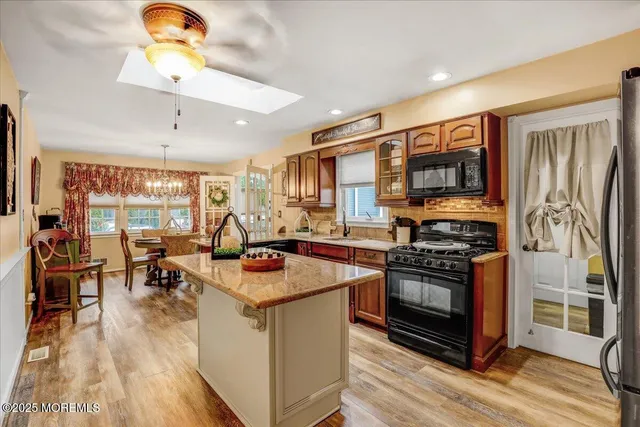 a kitchen with stainless steel appliances granite countertop a stove and refrigerator