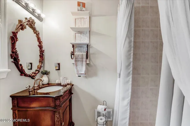 a bathroom with a sink mirror and vanity