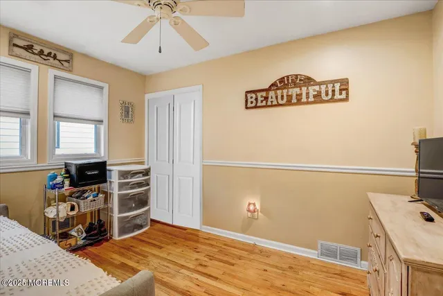 a view of a livingroom with wooden floor and a window