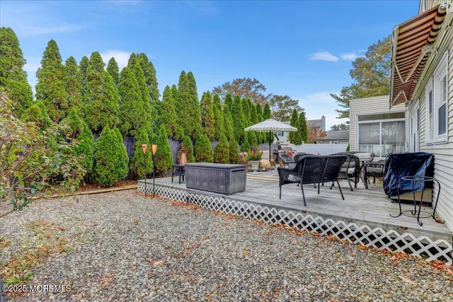 a view of a chairs and table in patio with a fire pit