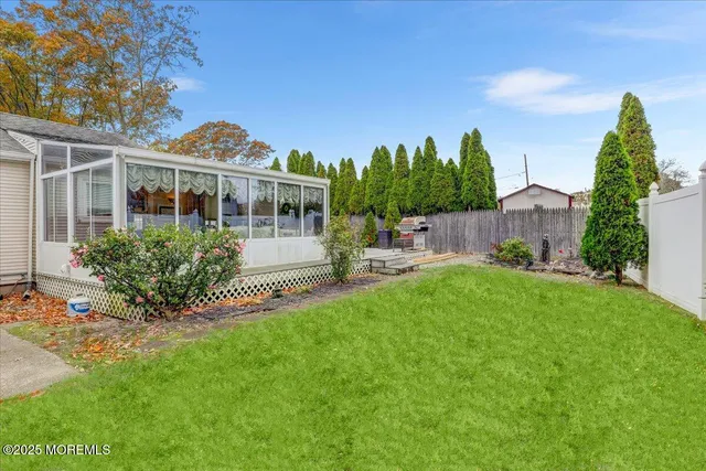 a view of a house with a backyard and a patio