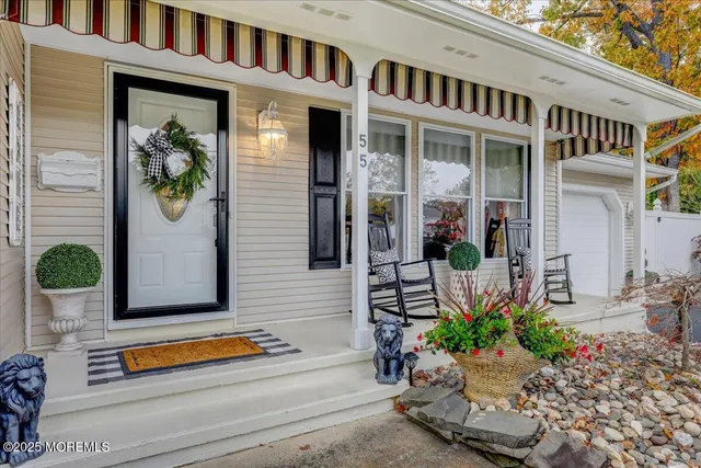 a front view of a house with a potted plant