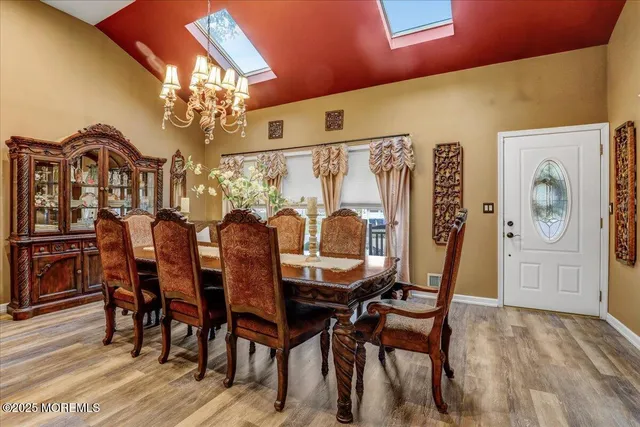 a view of a dining room with furniture and chandelier