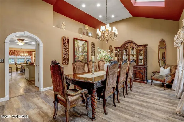 a view of a dining room with furniture and chandelier