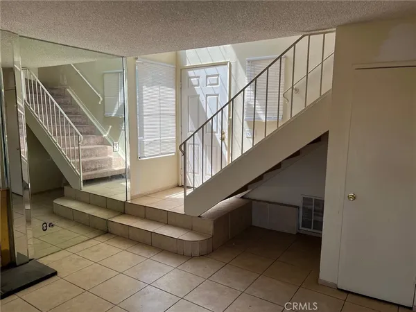 a view of a livingroom with a fireplace and window
