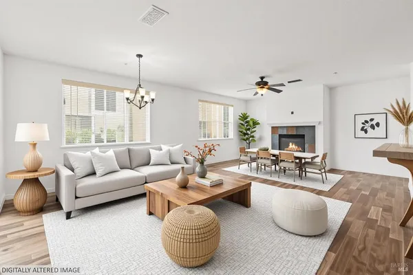 a living room with furniture potted plant and a chandelier