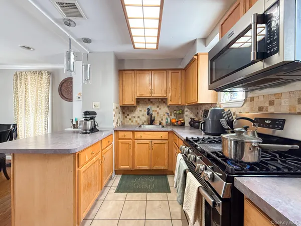 a kitchen with stainless steel appliances granite countertop a sink stove and cabinets