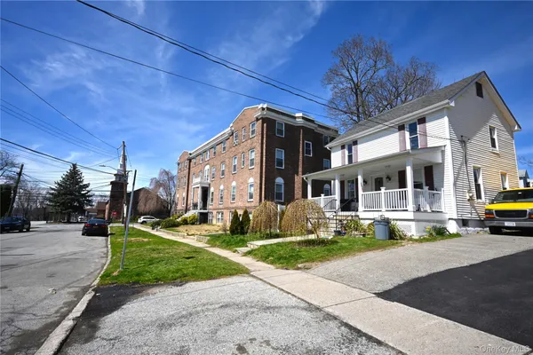 a front view of a house with a yard table and chairs