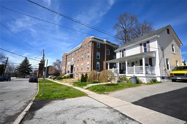 a front view of a house with a yard table and chairs