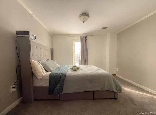 a bedroom with a bed chair and dresser