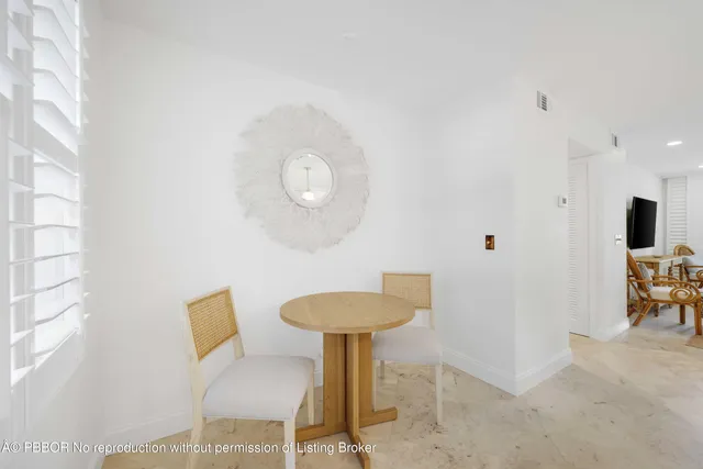 a view of a room with a table and chairs