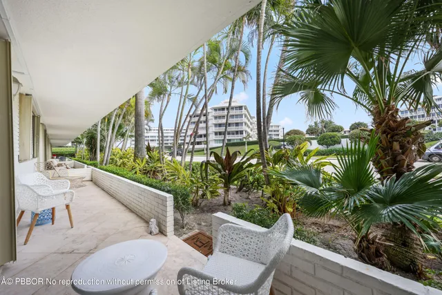 a view of balcony with furniture and garden