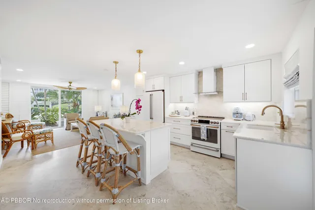 a kitchen with granite countertop a sink appliances and white cabinets