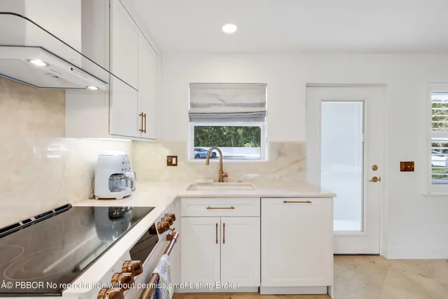 a kitchen with a sink stove and cabinets