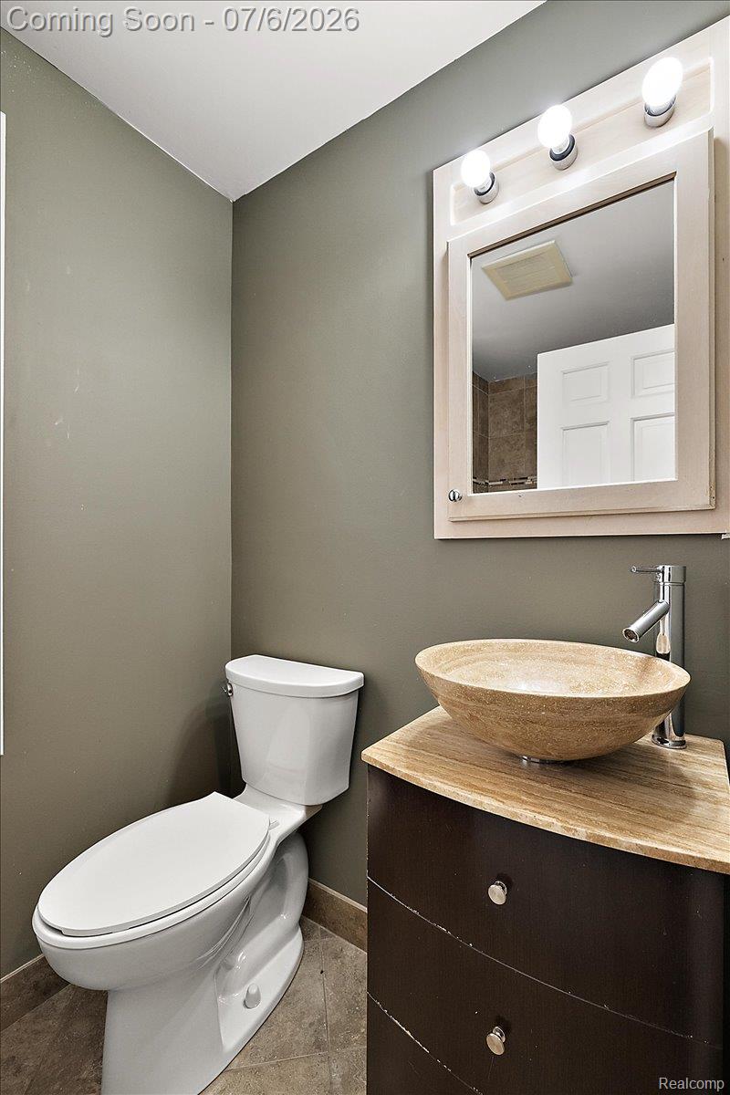 1051 Devonshire Road Grosse Pointe, MI 48230 - Photo 52 of 98 Modern vanity with a vessel sink, dark wood-finish cabinetry, and a light-toned countertop