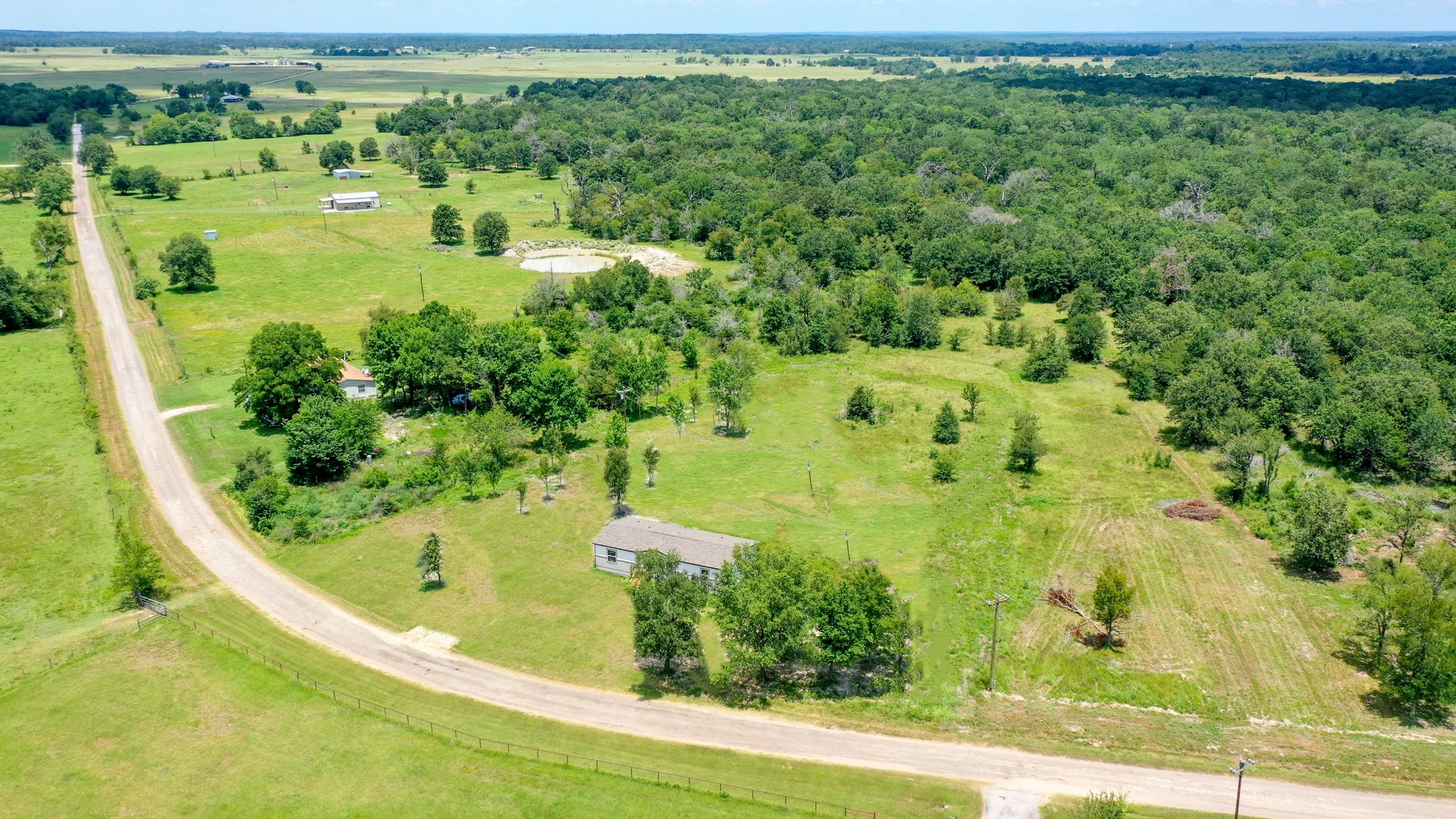 9960 Goose Prairie Road Midway, TX 75852 - Photo 3 of 28 Aerial Front View - AI Generated Grass