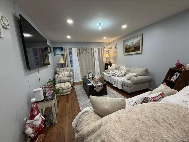 a bedroom with furniture and a flat screen tv