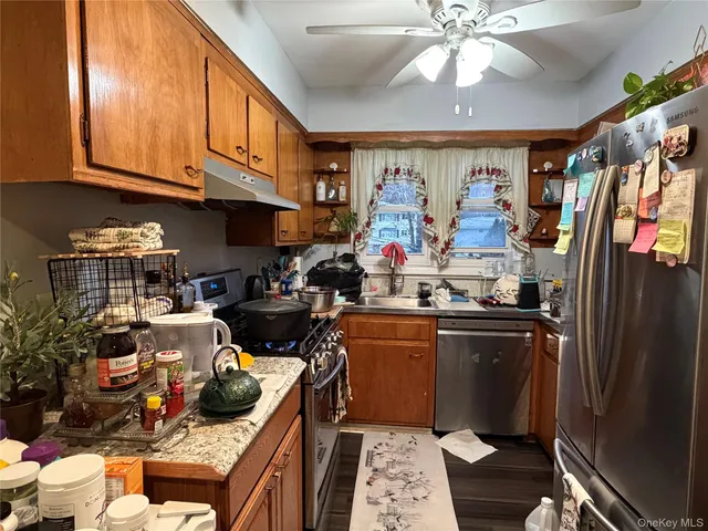a kitchen with stainless steel appliances granite countertop a stove and cabinets