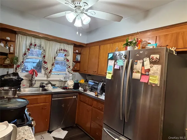 a kitchen with stainless steel appliances granite countertop a refrigerator and a sink