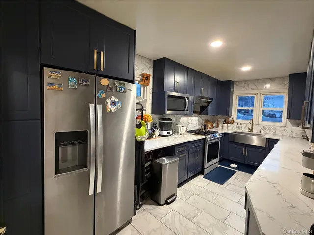 a kitchen with refrigerator a sink and cabinets