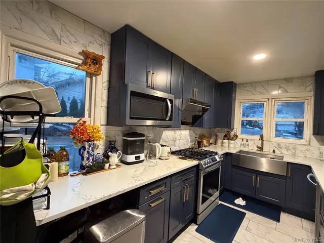 a kitchen with a sink stove and microwave