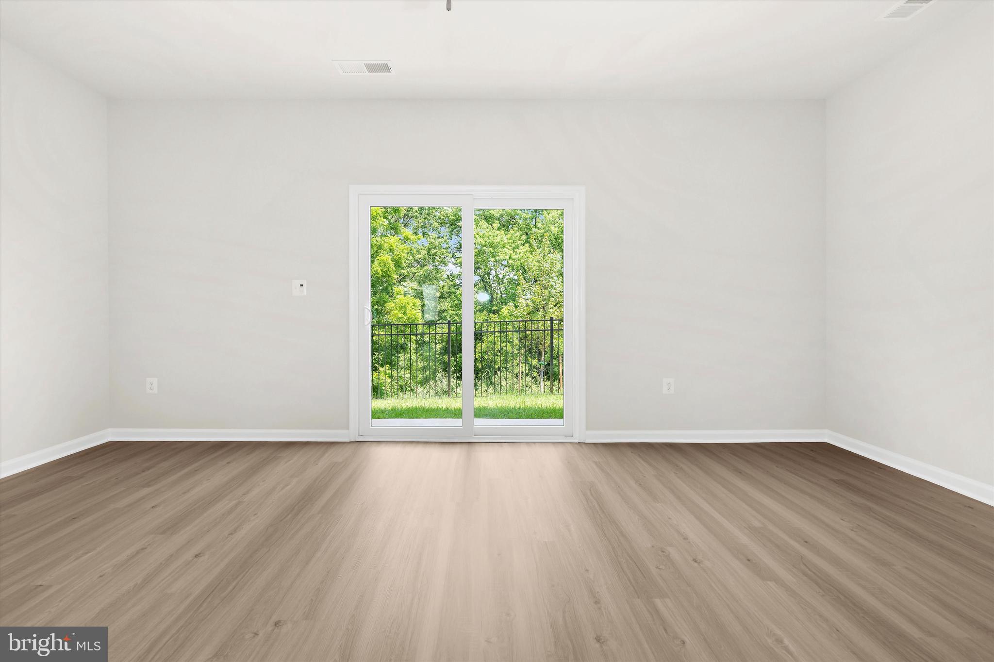 8131 Bartholomew Court Baltimore, MD 21206 - Photo 20 of 47 a view of an empty room with wooden floor and a window