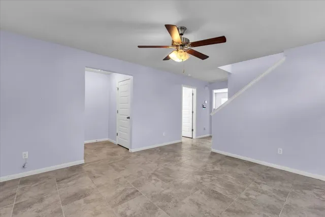 a view of room with a ceiling fan and window
