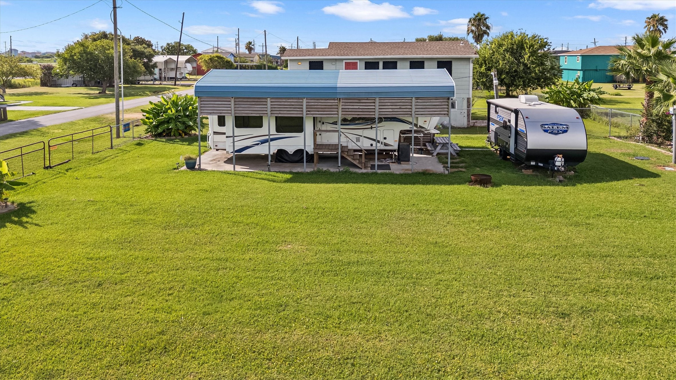 1061 E Road Port Bolivar, TX 77650 - Photo 6 of 28 a view of a swimming pool with lawn chairs and a yard