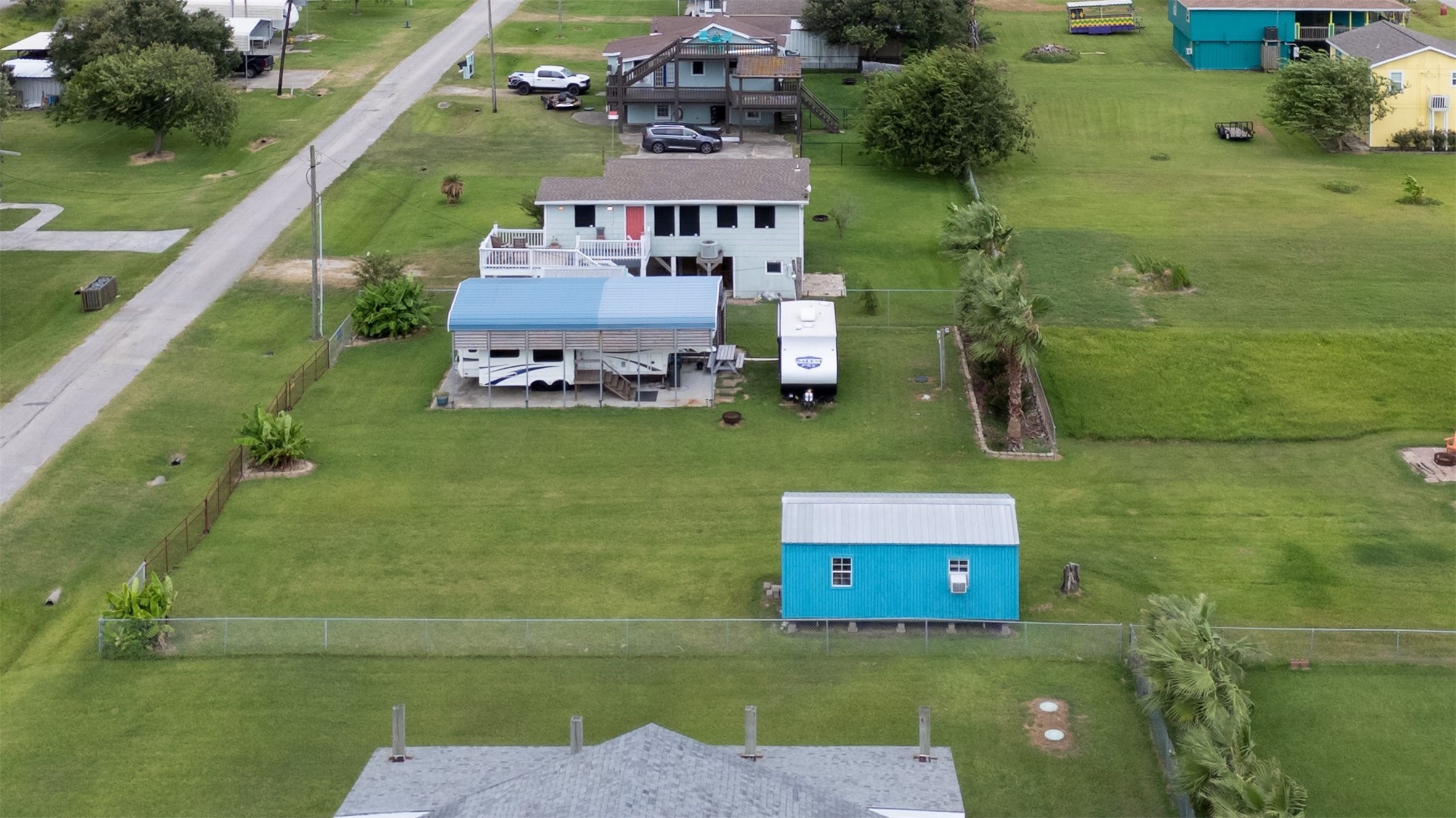 1061 E Road Port Bolivar, TX 77650 - Photo 9 of 28 a aerial view of a house with a garden and lake view