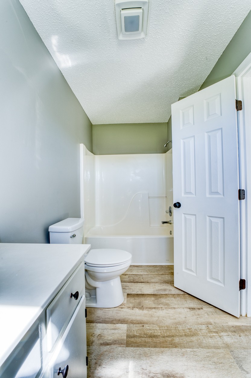 1464 Little Dry Creek Road Pulaski, TN 38478 - Photo 11 of 26 a bathroom with a toilet sink and vanity