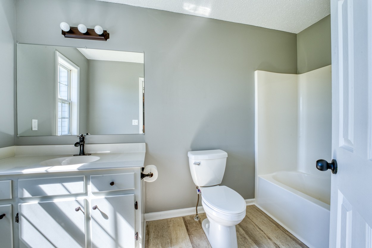 1464 Little Dry Creek Road Pulaski, TN 38478 - Photo 13 of 26 a bathroom with a sink toilet and shower
